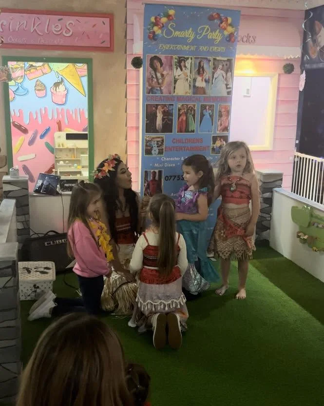 Children in dress-up outfits at Let’s Pretend’s fourth birthday celebration