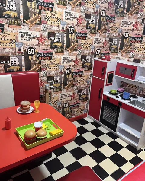 The pretend kitchen, little table and chequered floor in Al’s Diner