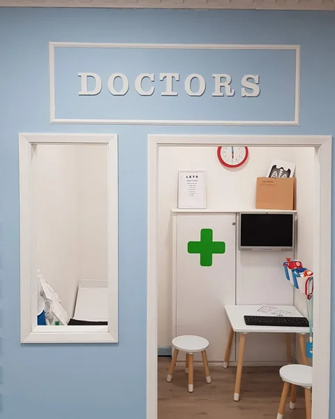 The Doctors play area, with a small examination room and green cross